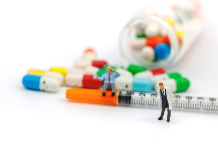 Miniature people: Fat Patients sitting on syringe with drugs and clock. Health care and business concept.の写真素材