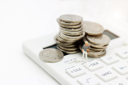Miniature people: Businesswoman standing on calculator with coins stack, Retirement planning, Emergency plan, Life insurance and Financial Concept.
の写真素材