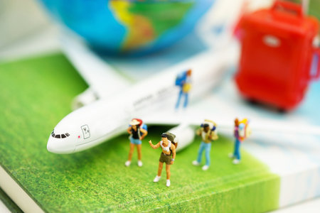 Miniature people: Traveller with backpack walking on the path of tourism by airplane. Travel, explore and adventure concept
の写真素材