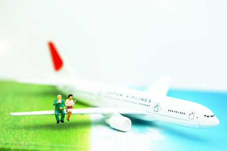 Miniature people: Traveller with backpack walking on the path of tourism by airplane. Travel, explore and adventure conceptの写真素材