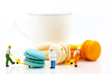 Miniature people: business team sitting on cup of coffee with morning news. Coffee time of business concept.の写真素材
