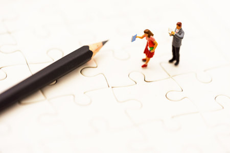 Miniature people: Business team reading book with pencil, education and business concept.の写真素材