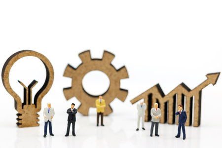 Miniature people:  Businessmen standing with graph, lamp idea, and cog symbol, Concept of Finance, investment and growth in business.の写真素材