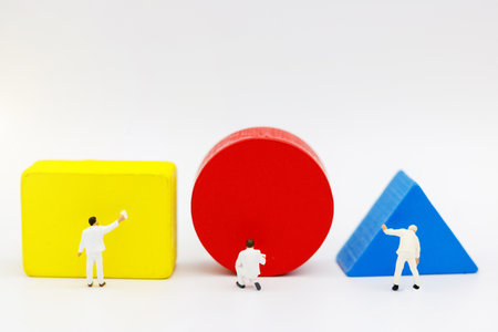 Miniature people: workers with paint colors for restoration and repair.の写真素材