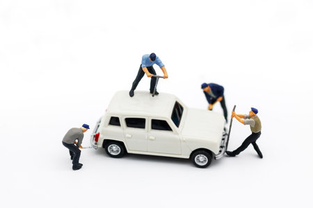 Miniature people: Workers fixing car. car service, repair, maintenance concept.の写真素材