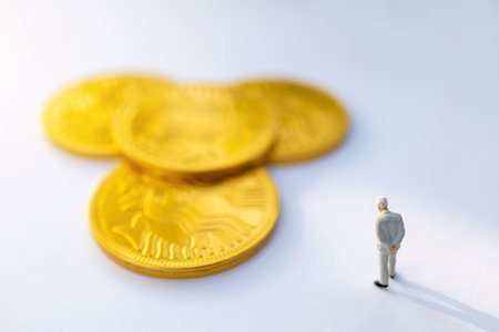 Miniature people:  Businessman stand and think about gold coins, Growth in business concept.の写真素材
