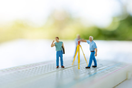Miniature people searching or checking for bugs and issue on microchip, mainboard of computer. Vulnerability search and security system concept.の写真素材
