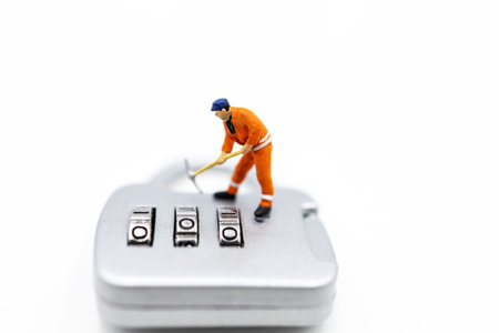 Miniature people: Worker hacking in padlock security. concept for data security breach, risk and hacker attack.の写真素材