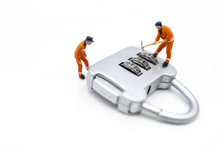 Miniature people: Worker hacking in padlock security. concept for data security breach, risk and hacker attack.の写真素材