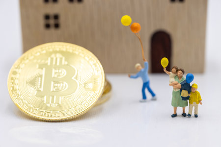 Miniature people standing with Gold bitcoin and house.  Concept of Business, Money, Technology, cryptocurrency and Investment.の写真素材