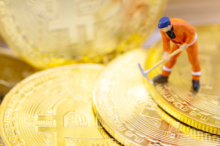 Miniature people miner figure working on Gold bitcoin.  Concept of Business, Money, Technology, cryptocurrency and Investment.の写真素材