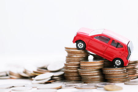 Little red car over a lot of money stacked coins and with background house. for loans costs concept....