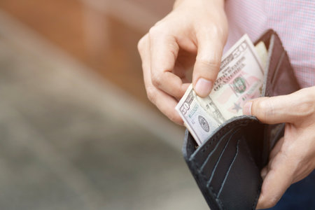close up Businessman Person holding an wallet in the hands of an man take money out of pocket. finance conceptの写真素材