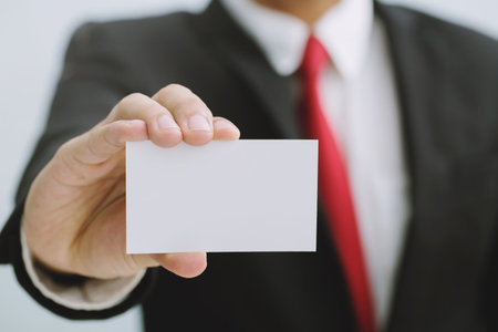 Young businessman who takes out blank business card from the pocket of his shirt business suit, copy spaceの写真素材