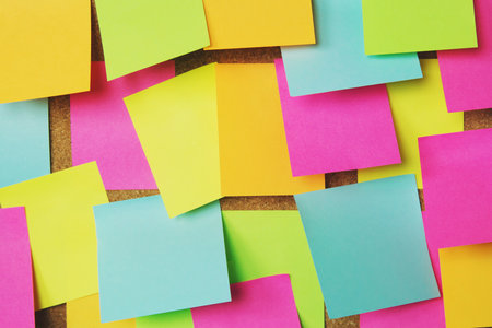 collection of colorful variety post it. paper note reminder sticky notes pin on cork bulletin board. empty space for text.の写真素材