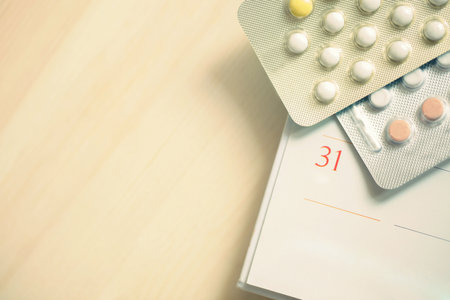 Contraceptive control pills on date of calendar background on the table wood. health care and medicine conceptの写真素材