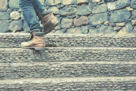 Close up legs of young hipster man One person walking stepping going up the stairs in modern city,...