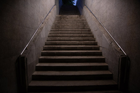 Stairs. subway staircase old in dark night secluded, concrete stairs in the city, stone granite stair steps often seen on monuments and landmarks, going up. Architectural details interiorsの写真素材
