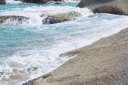 Sea Waves in ocean wave Splashing Ripple Water. Blue water background. Pound stone Rough water pounding granite rocks and coast. Sea wave and strong winds. nature islandの写真素材
