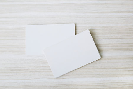 Business card on wooden background. Template for ID. Top view. Business card blank leave empty space...