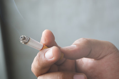 smoking Cigarettes tobacco close up in hand with a soft-focus. concept no quit Cigarettes are dangerous to health.の写真素材