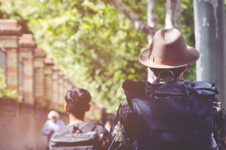 Group backpack of people young man on the street road in city downtown. traveler and tourist travel concept.の写真素材