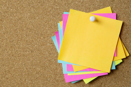 collection of colorful variety sticky notes. paper note reminder sticky notes pin on cork bulletin board. empty space for text.の写真素材