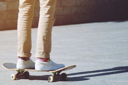 young man skateboarder on a skateboarding is riding on the road at city, Freestyle, Extreme Sports...
