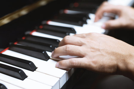 close up of hand people man musician playing piano keyboard with selective focus keys. can be used as a background.の写真素材