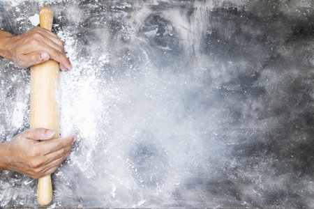 dough preparation recipe bread. Baking ingredients bakery cooking. butter on sackcloth, egg and flour on black board. flat lay on table Bare mortar cement style loft background. Top view, copy space.の写真素材