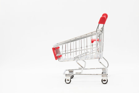 Empty grocery hand cart Shopping cart color red, Mini Supermarket Car Isolated On White Backgroundの写真素材