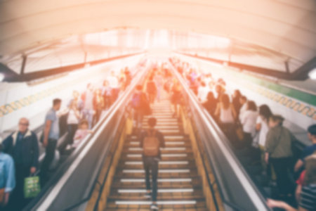 blur passenger people in the subway station walking using escalator and stair in pedestrian subway railway station in rush hour. metro underground travel concept. Europe. blurred motion. filter retroの写真素材