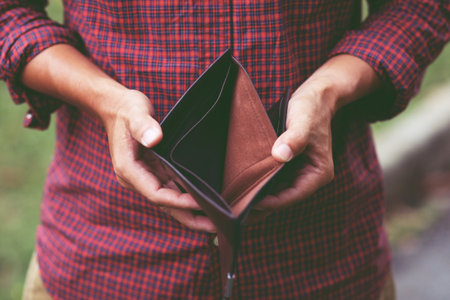 Empty wallet (no money) in the hands of an businessman. High cost of living in city Cost control...