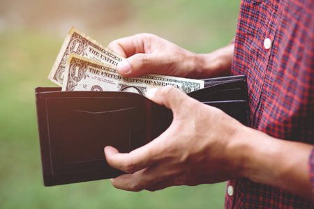 Business Person holding an wallet in the hands of an man no money have a little money. Poverty poor...