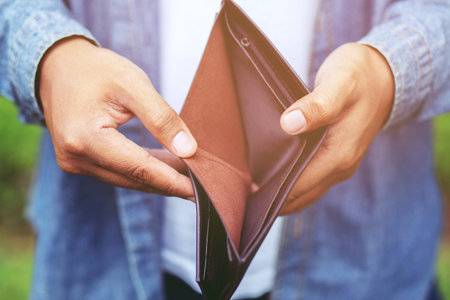 Business Person holding an empty wallet in the hands of an man no money. Poverty Bankruptcy in concept.の写真素材