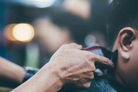 person man haircut getting stylish hair vintage shaving, with hair Scissors clipper and hair brush comb by barber hairdresser with hands at barbershop. filler Vintage Tone and Selective Soft Focus.の写真素材