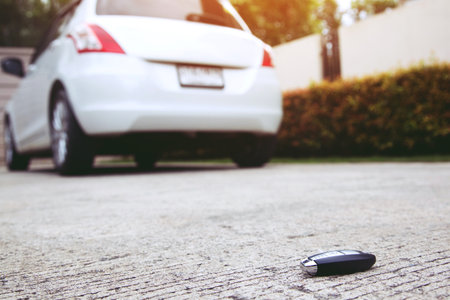 abstract lost car keys fall lying on the street concrete cement ground roadway home front yard.の写真素材