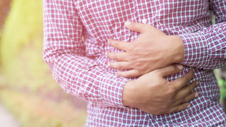 sick unhappy people man plaid shirt stand suffering from stomach ache. concept healthcare and health problem.の写真素材