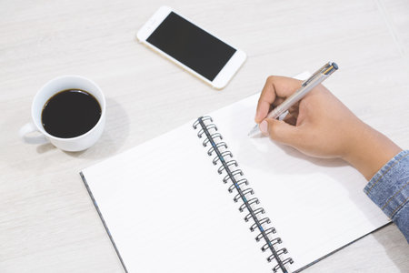 Close up of casual people business man sit drink coffee ,notepad and freelancer working on table and mobile smart phone with working or casual business concept lifestyle.の写真素材