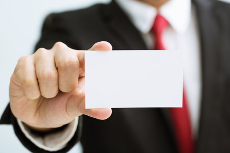 Young businessman who takes out blank business card from the pocket of his shirt business suit, copy spaceの写真素材