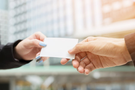 business woman in hand hold show business cards blank white card mock up filing give to connect business man contacts. Business branding concept.の写真素材