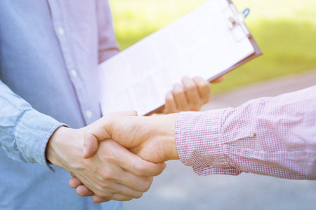 Close up of a business man hand shake between two colleagues greet , Represents Friendship is good,success, congratulations. copy leave space for text.の写真素材