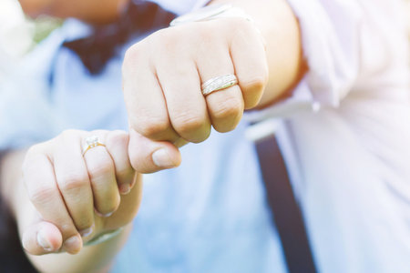 married wed couple holds hands and shows of there wedding Jewelry Diamond rings. loverの写真素材