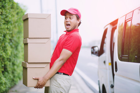 parcel delivery man stand beside van counting Check stock Prepare to send the package to the customer. Validate every time in transportation. In order not to make mistakes in the work.の写真素材