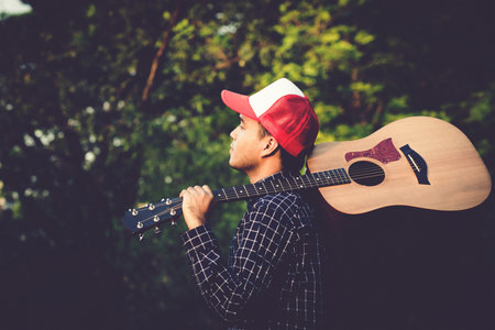 Acoustic guitar. Musical instrument with performer hands in parks.の写真素材