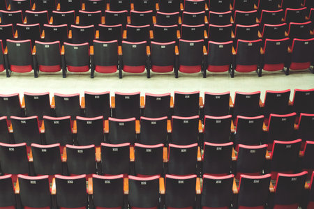 Empty comfortable red black seats with numbers in cinema / theater empty seats.の写真素材