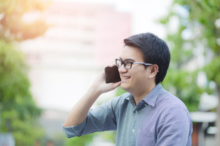 Handsome Business man in an using telephone glad.の写真素材