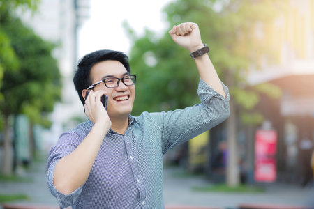 Handsome Business man in an using telephone glad.の写真素材