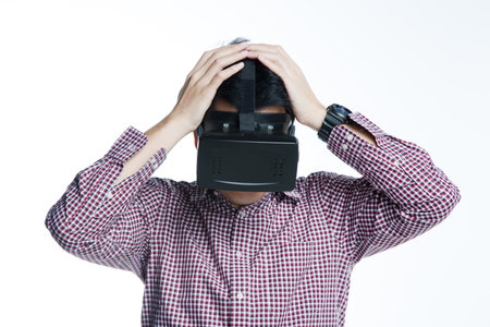 Man wearing virtual reality goggles excited impassioned mood. Studio shot, white background.の写真素材