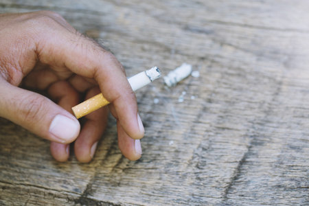 man smoking a cigarette. Cigarette smoke spread.の写真素材